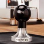Profitec Tamper Edelstahl mit schwarzem Griff auf Tampermatte
