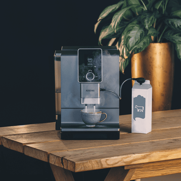 NIVONA Milchlanze NIML220 mit Kaffeevollautomat auf Holztisch